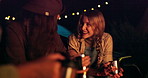 Night, camping and women with coffee, friends and smile on late outdoor adventure at tent. Campfire, hot drinks and people in dark at campsite for holiday, relax and happy talking in nature with cup