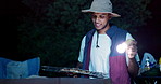 Camping, bbq and man at night with grill for meat, food and supper in forest, woods or nature. Travel, campsite and person with torch for barbecue, cooking and meal preparation on holiday or vacation