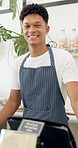 Barista, cafe and face of man with smile for friendly service, confidence and pride by counter. Small business, startup and portrait of happy waiter in restaurant, diner and coffee shop for welcome