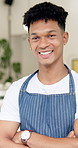 Face, barista and man with arms crossed, apron and confidence with small business, restaurant and startup. Portrait, waiter and employee with success and service industry with hospitality and cafe