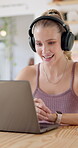 Woman, freelancer and video call at cafe for virtual meeting, discussion and communication on her laptop. Startup or creative worker on computer and headphones for copywriting feedback at coffee shop