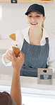 Woman, ice cream and customer at counter in shop with smile for service, helping hand and cone for snack. Waitress, server or scooper with dessert, gelato or vanilla product in store with client