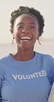 Woman, face and volunteer on beach for pollution community service, environment or sustainability. Black person, smile and activist as earth day project or charity, waste management or climate change