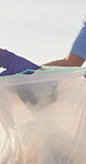 Volunteer, team work and plastic bag with garbage in environment for clean up, activism or community service. People, hands and trash collection on beach or earth day project, eco friendly or recycle