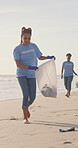 Women, volunteer and teamwork on beach for garbage clean up as community service, pollution or plastic. Female people, trash bag and activist group for climate change recycling, waste or conservation