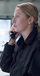 Security, woman and telephone in control room for talking, communication and report on night watch for safety. Person, agent or guard with phone call for surveillance information in contact center