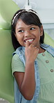 Dental care, oral hygiene and teeth with indian child at dentist in chair for appointment or checkup. Consulting, healthcare and medical with happy girl patient in clinic for teeth whitening