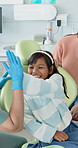 Girl, dentist and high five with smile, checkup and education for oral hygiene and appointment. Child, healthcare and dental care with tooth decay prevention and orthodontist visit in medical clinic