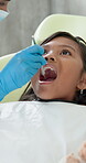 Dentist, check and child with tool for teeth in dental clinic with pediatric for healthy smile with treatment. Appointment, patient and visit for checkup with medical professional in oral healthcare