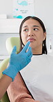 Appointment, worry and asian woman talking to dentist in office for dental care or medical checkup. Healthcare, oral hygiene and nervous patient with person in chair for consulting or teeth cleaning