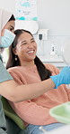 Happy, patient and dentist with results in consultation for teeth whitening, cleaning and inspection. Diversity, dentistry and women in clinic with smile for oral hygiene, dental care and appointment