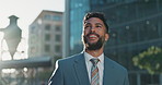 Smile, pride and young businessman in city looking at buildings for corporate office. Happy, professional and male financial advisor standing in town with positive, proud and confident attitude.