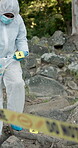 Crime scene, evidence markers and forensic investigation in woods with hazard suit in mountains. Cop, robbery or struggle for murder of victim with police for information with missing persons report