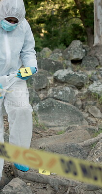 Crime scene, evidence markers and forensic investigation in woods with ...