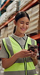 Happy woman, typing and supply chain with phone in logistics, communication or texting at warehouse. Female person or contractor with smile on mobile smartphone for online chat in storage at depot