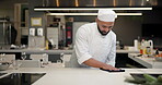 Chef, cloth and cleaning on table in kitchen for maintenance, food safety and disinfection. Hospitality, hygiene and man with fabric at restaurant for compliance, bacteria removal and sanitation