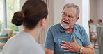 Nurse, senior and man with chest pain, communication for advice or healthcare and crisis in retirement home for care. Caregiver, mature male person and consulting for symptoms of pneumonia infection.