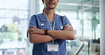 Woman, nurse and hands or arms crossed as professional for hospital confidence, pride or assistant. Female person, smile and medical consultation in free clinic for service, volunteer or healthcare