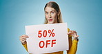 Girl, face and wow in studio with poster for clearance sale for retail or marketing for advertisement news. Woman, billboard and blue background for fashion promotion, app offer and announcement.