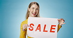 Girl, face and dancing in studio with poster for clearance sale for retail or marketing for advertisement news. Woman, billboard and blue background for fashion promotion, app offer and announcement.