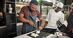 Chef, cooking class and onions in kitchen for learn, teacher and food for professional skills. Restaurant, cutting or culinary student with knife, vegetables jubilee and preparation for recipe