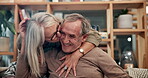 Mature, couple and hugging with kiss on sofa in home with embrace, retirement and relax with closeup. Senior, people and happy on couch with healthy marriage, bonding and love with care or affection