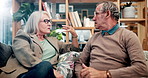 Old people, couple and argument on sofa in home for financial trouble in retirement, disagreement or conflict. Man, woman and angry talking or fight with frustrated in living room, unhappy or stress