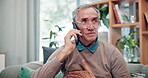 Senior man, home and phone call with medical online consultation and telehealth for cardiology. Heart pain, retirement and conversation on a mobile with healthcare and doctor advice on a sofa
