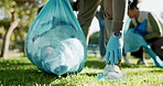 Hands, plastic bag or person in park for bottle, waste management or recycling in community service. Environment, sustainability or volunteer closeup for garbage, junk or picking rubbish on ground