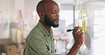 Sticky notes, meeting and businessman writing idea, vision and brainstorming in office. Black man with notes on glass wall for presentation in business meeting, thinking and working on ideas