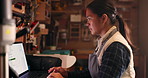 Woman, workshop and carpenter with a laptop, business and typing with email notification, connection or invoice. Japanese person, employee or entrepreneur with a pc, search internet or online reading