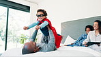 Man, child and superhero or bed play for morning connection or costume, game or holiday. Male person, son and hand for kid balance pose on mattress for mother bonding, siblings or together