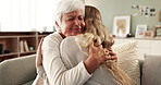 Love, hug and woman on couch with grandmother with smile, bonding and senior care in living room. Respect, embrace and girl on sofa together with grandma for support, comfort and happiness in home.