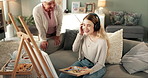 Headphones, woman and painting in living room with proud grandmother and canvas in a home. Painter, music and audio with creative drawing and sketch with a grandparent compliment of art and talent