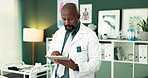 Black man, doctor and research with tablet for medical study, new discovery or online browsing at hospital. African, male person or surgeon scrolling with technology for medicine or clinical trial