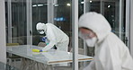 Cleaning, disinfection and people with hazmat suit in laboratory for germs, virus exposure or prevent infection. Biohazard, hygiene and staff with ppe for decontamination, chemical or hazardous waste