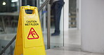 Cleaner, mopping and office with caution sign, janitor and hygiene service and wet floor for healthcare. Attention, safety and warning for risk, slippery and person clean or disinfect for maintenance