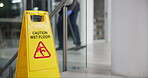 Person, mopping and office with caution sign, janitor and hygiene service and wet floor for healthcare. Attention, safety and warning for risk, dancing and cleaner happy for cleaning or maintenance