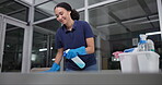 Woman, wipe and spray for cleaning in office, disinfection and janitor for liquid soap. Female person, maintenance service and chemical treatment to prevent germs, bacteria and disease at night