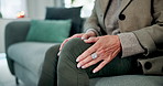 Knee pain, sofa and hands of senior woman in home with osteoporosis, arthritis and inflammation. Healthcare, retirement and legs of elderly person with worry for injury, accident and sprain on couch