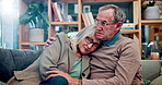 Old couple, hug and grief comfort on sofa in home for mental health sadness, loss or compassion. Men, woman and embrace on couch in retirement for depression support or sympathy, security or marriage