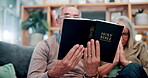 Senior couple, home and reading bible in sofa with praying for faith, worship and healing. People, relationship and Christian with spiritual practice or study scripture for hope, trust and religion