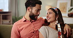 Happy couple, relax and hug on sofa with love, support and talking of future together at home or apartment. Interracial man and woman laughing, cuddle and excited on couch or living room for holiday