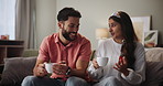 Home, talking and couple with coffee on sofa in morning, commitment and bonding together. Happy people, man and woman with smile on couch for conversation, romance and dating in relationship