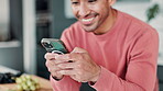 Man, smartphone and typing with laugh in kitchen with funny video or social media app in house. Online, texting and relax on weekend with comedy or good news notification with chatting in Canada