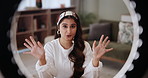 Broadcast, ring light and social media with Indian woman influencer streaming in living room of home. Portrait, streaming and talking with happy content creator in apartment for online vlogging