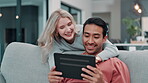 Couple, speaking and home with couch and tablet, love and bonding for relationship on website for streaming. Social media, networking and watching video online, internet shopping in living room