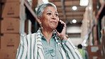 Woman, mature and manager in warehouse on call with smartphone for logistics with order confirmation. Shipping, freight and manufacturer for industrial with supply chain or female foreman with boxes