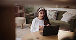 Indian woman, talking and video call with laptop for communication, proposal or speech in living room at home. Female person, journalist or influencer speaking on computer for online tutorial or tips