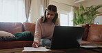 Indian woman, paperwork and laptop with stress for debt on sofa in home with bankruptcy, inflation and overdraft bill. Girl, financial payment and documents with anxiety for online banking and loan